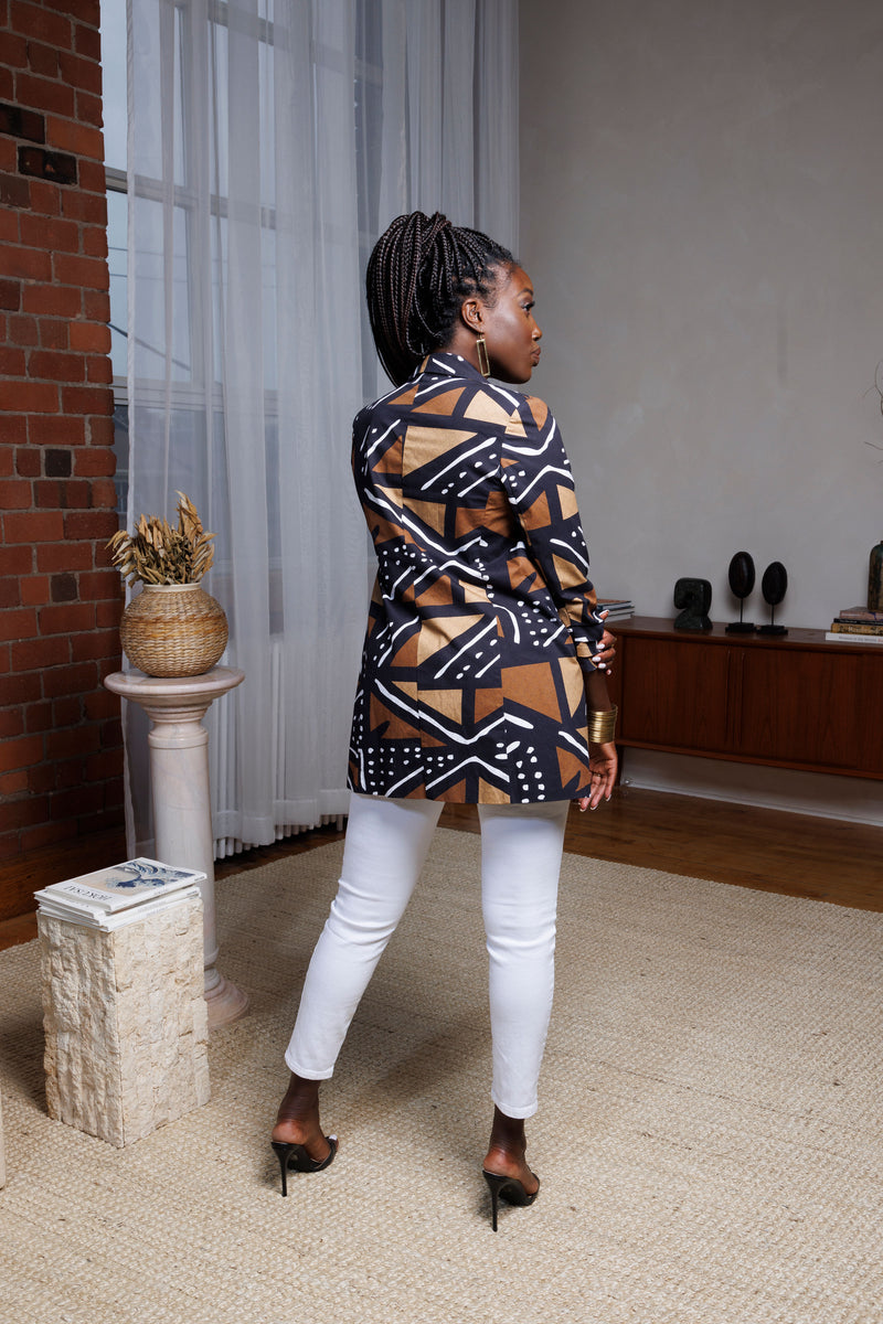 Model wearing Tara African print blazer and white pants back view