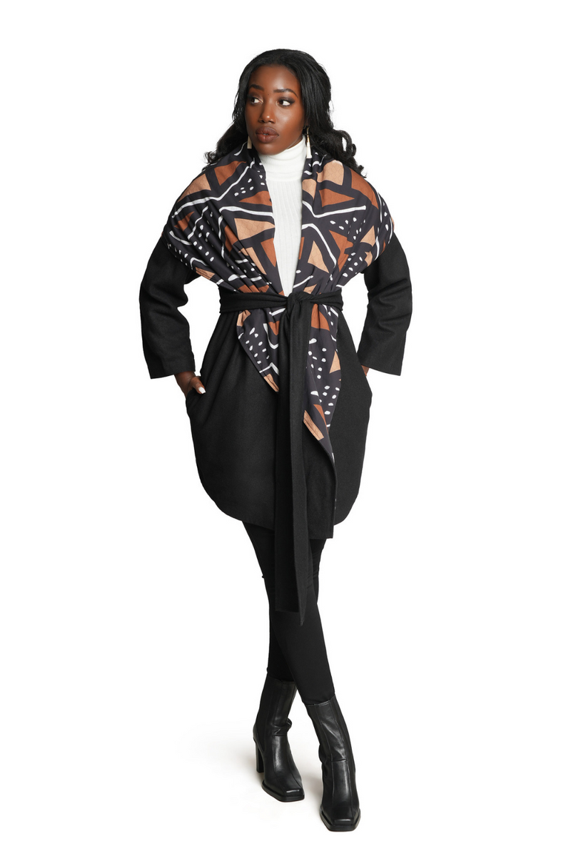 woman wearing mudcloth african print coat with tie belt in black